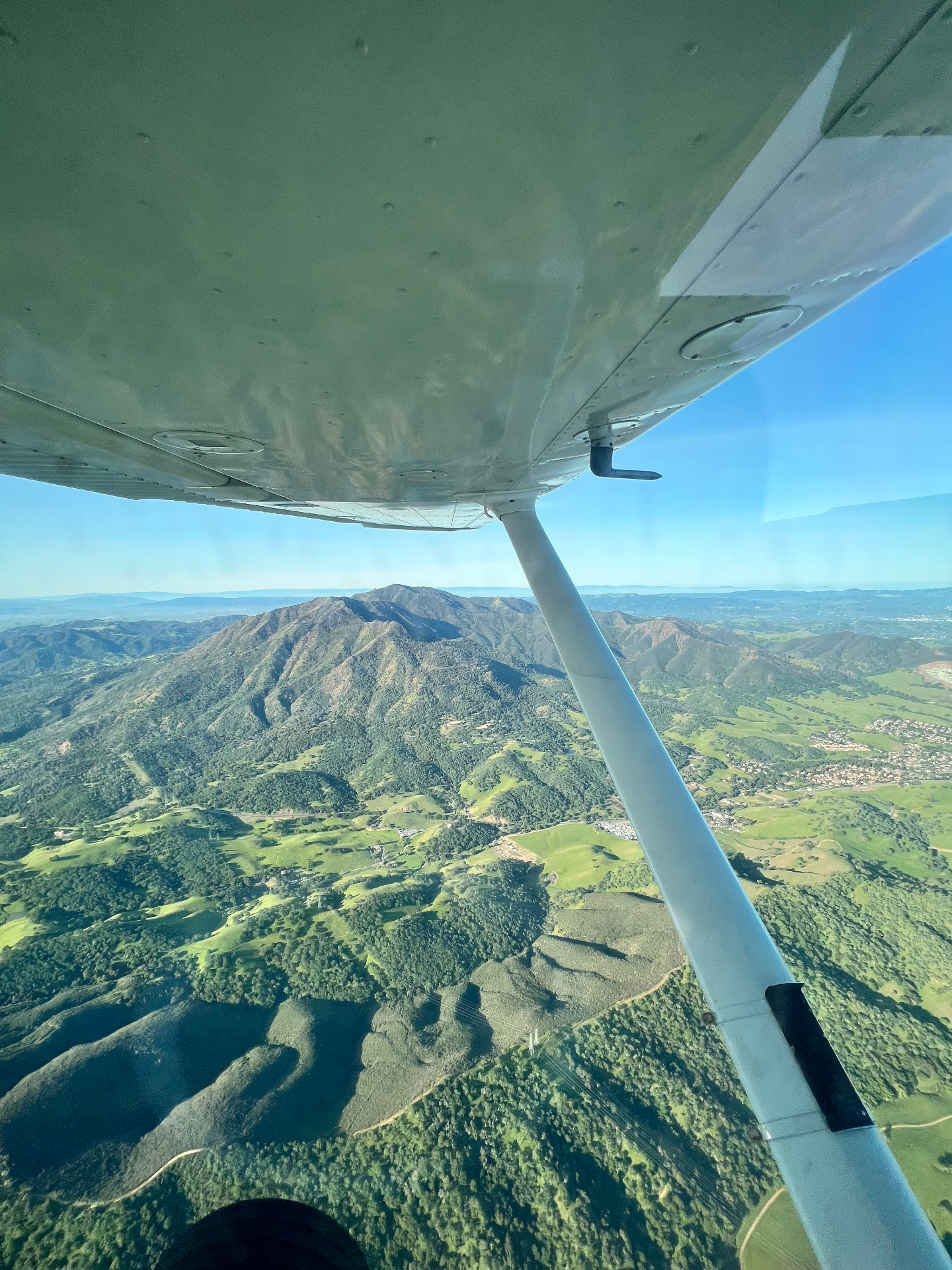 Aerial view from a Cessna over Mount Diablo and the green East Bay hills near Concord, California